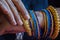 Stock photo of a hand of Indian women wearing colorful bangles with gold Indian design bracelet, picture captured at the time of