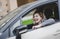 Stock photo of A happy young girl smiling driving a car