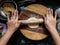 Stock photo of Indian women hand rolling wheat flour dough with rolling pin, for making puri, chapati or paratha. wooden rolling