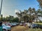 Stock photo of parked four wheeler car, tempo, auto rickshaw outside of temple area under