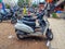 stock photo showcases a scene where bike, and scooter, auto are parked outside a shop, a few