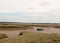 Stock Photo - single deserted boat in mud of landscape harwich f