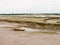 Stock Photo - single old boat in mud sea coast no people browns