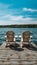 Stock photo Two Adirondack chairs on wooden dock facing blue water