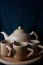 Stock photos of several cups of tea as well as a brown pottery teapot and very neatly arranged. suitable for business about tea,