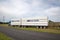 A stock truck leaves a farm after loading up with sheep in New Zealand