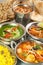 Stock of various indian food in metal bowls and on metal plates