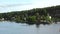 Stockholm Archipelago. Swedish archipelago nature on sunny day in summer. Green forest trees at shoreline. Sweden nature