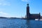 Stockholm city hall in daylight against a blue sky.