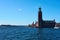 Stockholm city hall in daylight against a blue sky.