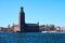 Stockholm city hall in daylight against a blue sky.