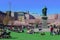 STOCKHOLM, SWEDEN - APRIL 28, 2019: Families sitting on green grass near statue of Swedish king Charles XIII in Kungstradgarden