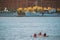 Stockholm, Sweden. People Floating On Kayak Near Scenic Famous View Of Embankment In Old Town Of Stockholm At Summer
