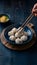 StockImage Traditional Korean Mandu dumplings presented elegantly with chopsticks