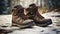 stockphoto, Hiker\\\'s Boots in the snow. Empty used hiking boots standing on the soil in a snowy landscape