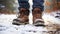 stockphoto, Hiker\\\'s Boots in the snow. Empty used hiking boots standing on the soil in a snowy landscape.