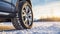 stockphoto, Winter tire. SUV car on snow road. Tires on snowy highway detail. close up view. Space for text.
