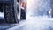 stockphoto, Winter tire. truck on snow road. Tires on snowy highway detail. close up view. Copy space.