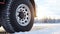 stockphoto, Winter tire. truck on snow road. Tires on snowy highway detail. close up view. Copy space.