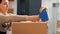 Stockroom manager sealing off cardboard boxes in depot