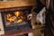 Stoke fireplace. Brass fireplace tongs in hand man