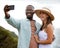 She stole my heart right from the start. a happy young couple taking selfies on a road trip along the coast.