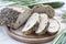 Stollen traditional German Christmas yeast cake with raisins served with a cup of coffee decorated with tablecloth on wooden table