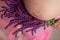 Stomach of the pregnant woman in a frame of lilac flowers