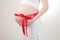 Stomachs of pregnant women tied a scarlet ribbon