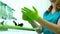 Stomatological nurse wearing green protective gloves, high quality service