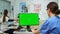 Stomatologist nurse looking at green screen tablet