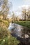 Stonavka river with trees and clouds mirroring in Karvina city in Czech republic