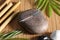 Stone with acupuncture needles on bamboo mat, above view