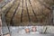 Stone age material weaving frame and ceramic pots inside a hut in the Mondragon Palace museum, Ronda, Spain.