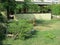 Stone arbor in a private sector with green vegetation.