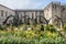 Stone arcada in the flowers garden.