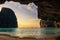 Stone arch cave of Maya beach at sunset