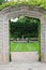 A stone arch entry, covered in a vine, framing a sunken garden, at Rotary Botanic Gardens in Janesville, Wisconsin