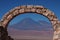 Stone arch in front of a volcano in chile