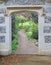 Stone arch gateway door entrance to beautiful garden flowers plants