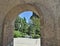 A stone arch to a green park heaven