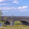 Stone arched bridge overlooking lake and sky