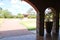 Stone arches and flower pots in country house with garden in the background