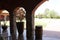 Stone arches and flower pots in country house with garden in the background