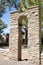 Stone archway bell tower with brass bell