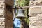 Stone archway bell tower with brass bell