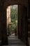 Stone archway leading to a curved staircase in Pitigliano, Italy