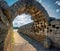 stone archway leading to the historic stadium of the Ancient Olympia