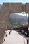 A stone archway leading to a row of vendors in front of the Ollantaytambo train station in Peru, South America