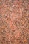 Stone Background of rough red granite igneous rock